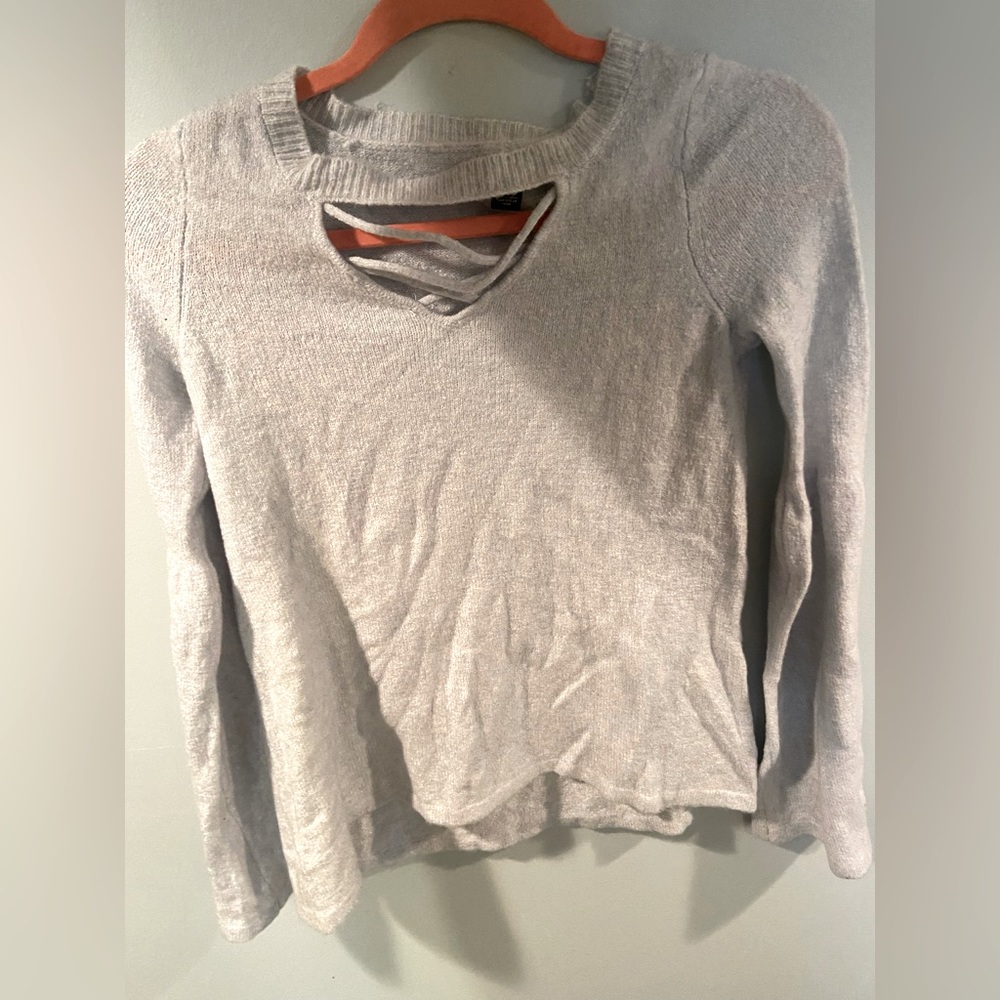 American eagle sweater like top. Cross cross pattern in front bell sleeves.